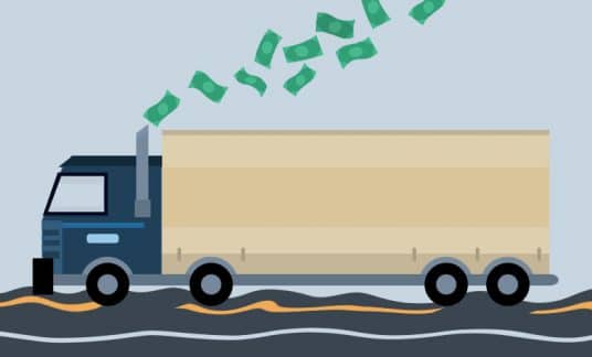 A semi-truck hauling a big trailer rolls down a bumpy road. A stream of dollar bills are coming out of its stack.