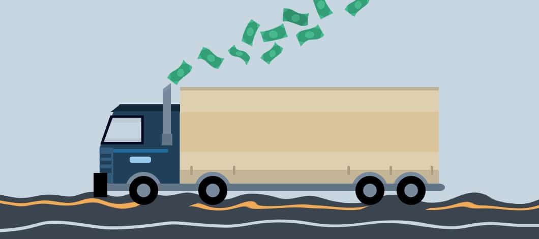 A semi-truck hauling a big trailer rolls down a bumpy road. A stream of dollar bills are coming out of its stack. Thankfully, there are ways to address cash-flow challenges facing the trucking industry