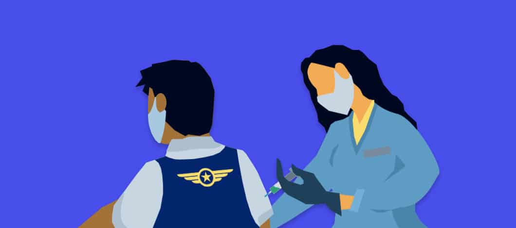 An airline employee wearing a mask gets a vaccination shot from a masked medical professional.
