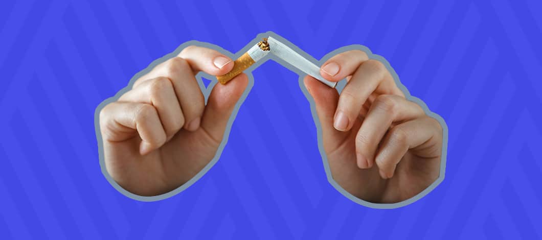 Two hands snap a cigarette in two.
