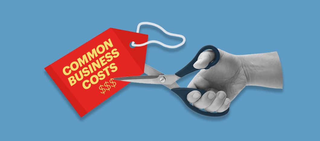 A price tag labeled “Common Business Costs” is about to be cut by a pair of scissors.