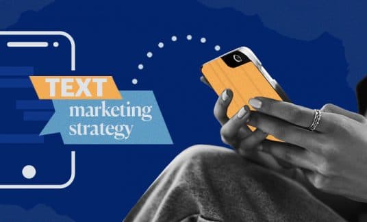Two hands hold a cellphone and type the words “Text Marketing Strategy” in a text message.